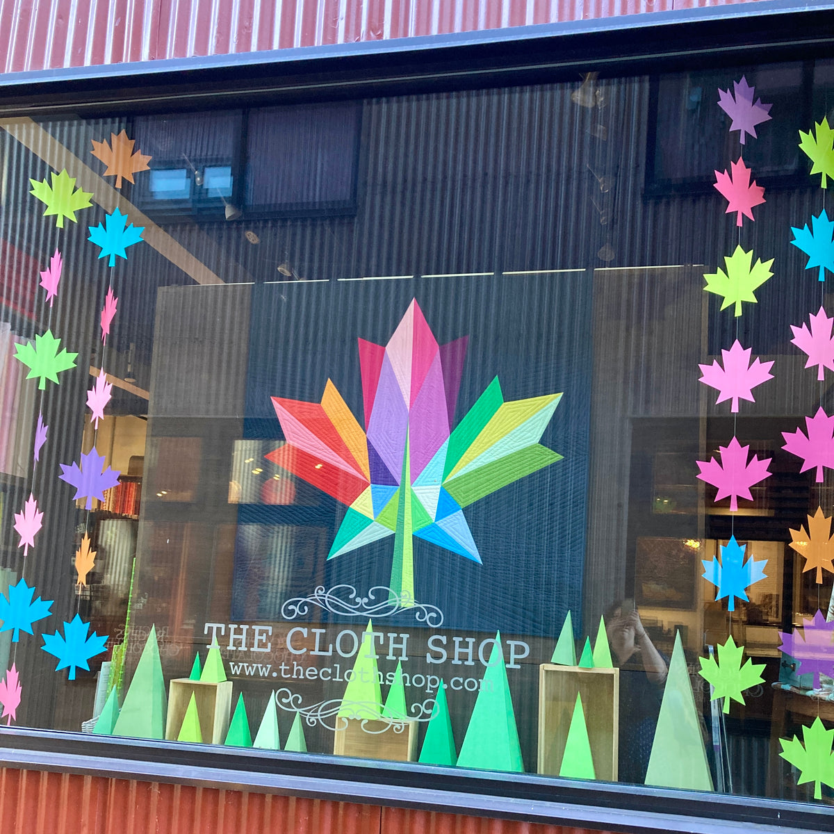 Store window display featuring Canadian maple leaf quilt design. Quilt pattern, fabric, and quilt kit available online and in-store at The Cloth Shop.